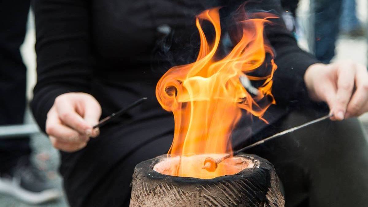 ANU College of Art and Design graduate Emeirely Nucifora-Ryan creates glass beads over a traditional fire bead furnaces.