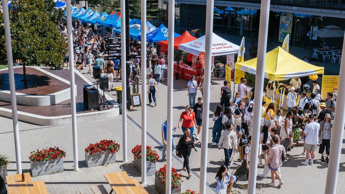 Market stalls along University Ave surrounded by hundreds of students participating in O-Week.