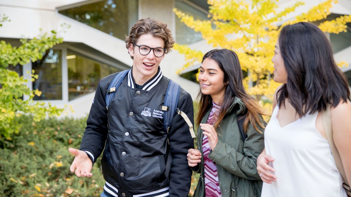 Three students walk to class. 